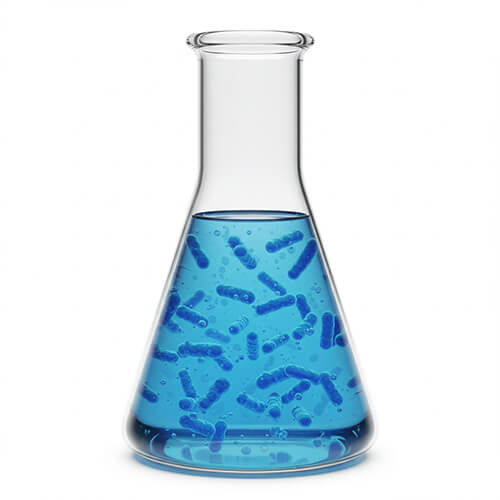 NT-MAX biological pond treatment microbes suspended in vivid blue solution within a glass laboratory beaker