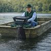 Ironvale granular spreader mounted on aluminum boat applying treatment to lake water.