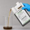 Alligare 2,4 D 32 oz being poured into a graduated beaker for precise measurement before application.