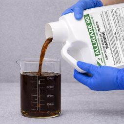 Alligare 90 Adjuvant Surfactant being poured into a graduated beaker for precise measurement before application.