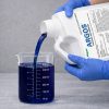 Alligare Argos 1 gallon being poured into a graduated beaker for precise measurement before application.
