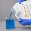 Alligare Ecomazapyr 2 SL 2 and a half gallon being poured into a graduated beaker for precise measurement before application.