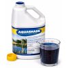 Dark blue Aquashade liquid measured in a clear cup beside the opened 1 gallon jug.