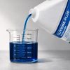 Cutrine Plus liquid algaecide being poured into a graduated beaker for precise measurement before application.