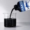 MAKO 5x concentrate black lake and pond dye pouring into a measuring container.