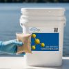 NT-MAX Clarifier + Sludge and Muck Digester packet next to a 5-gallon bucket for size reference.