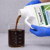 Reward Landscape and Aquatic Herbicide being poured into a graduated beaker for precise measurement before application.