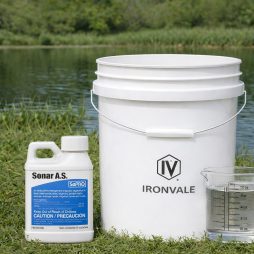 SePRO Sonar A.S. 8 oz bottle beside a 5-gallon bucket and graduated measuring cup for size reference