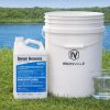 Sonar Genesis 1 gallon bottle beside a 5-gallon bucket and graduated measuring cup for size reference