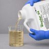 Weedar 64 Herbicide 2 and half gallon being poured into a graduated beaker for precise measurement before application.